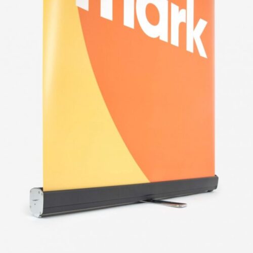 Nahaufnahme eines Roll-up-Banners mit einem Teil des Wortes „Mark“ auf orangefarbenem und gelbem Hintergrund.