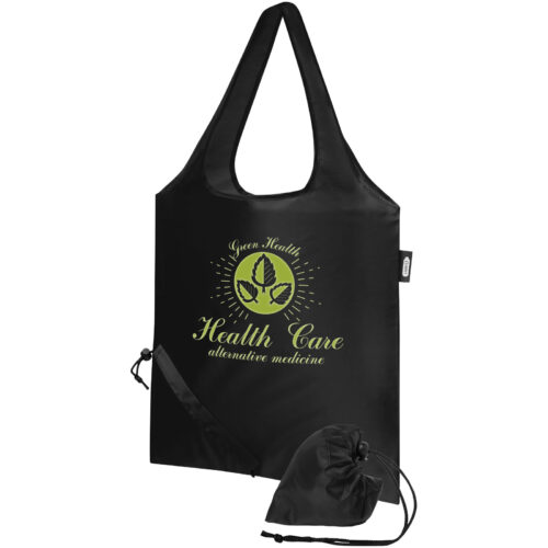 Schwarze, wiederverwendbare Tasche mit dem Design „Health Care – Alternativmedizin“ und grünen Blättern, dazu ein Beutel mit Kordelzug.